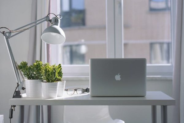 Silver Macbook Air and Goose Neck Lamp